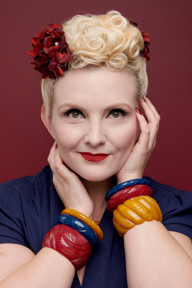 Splendette vintage inspired 1940s Bakelite style Golden Autumn fakelite jewellery model headshot with Bordeaux, Ink and Mustard bangles, Bordeaux necklace and Mustard Drop Hoop Earrings vertical