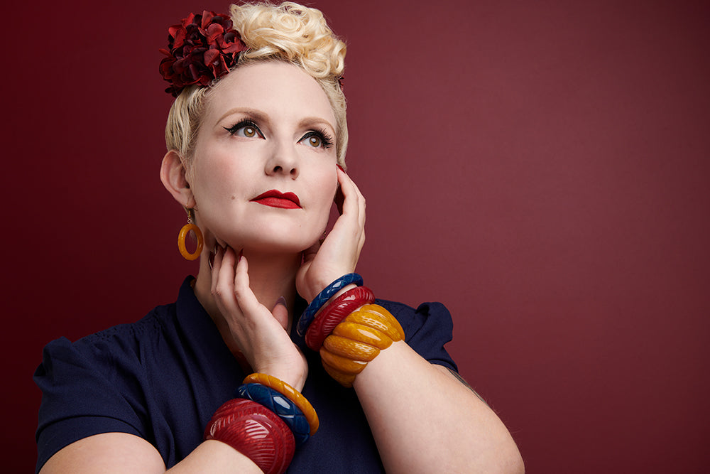 Splendette vintage inspired 1940s style model wearing Autumn 2020 Golden Fakelite range, including red Bordeaux, yellow Mustard, and blue Ink