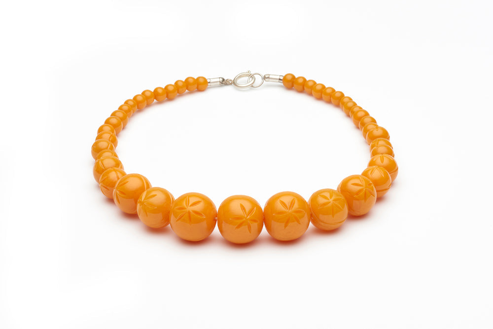 Carved Pale Orange Fakelite Beads