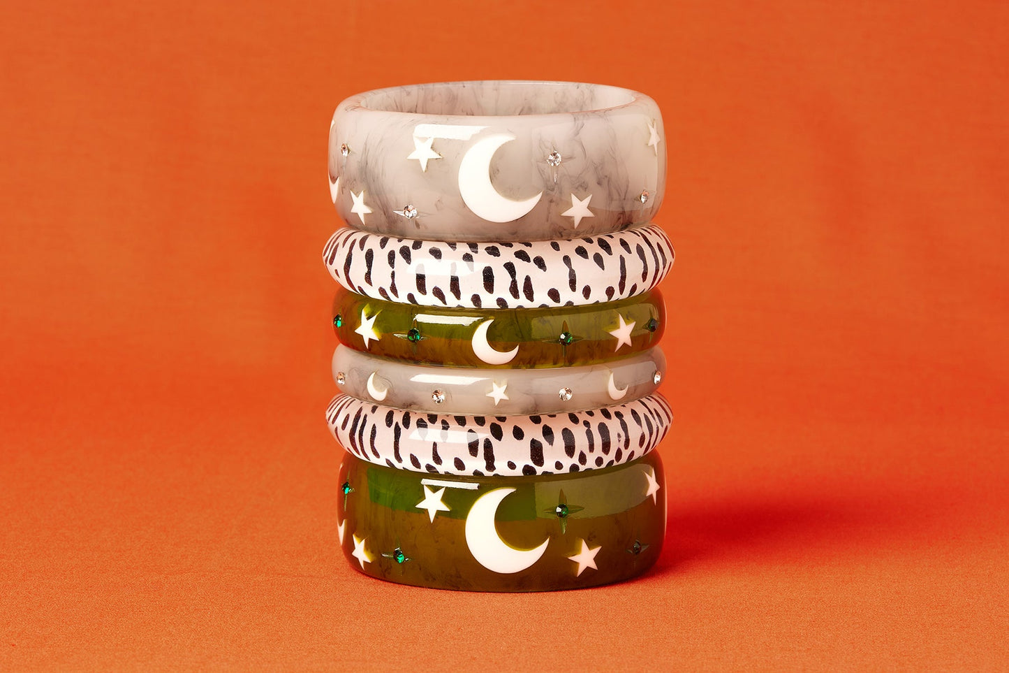 Splendette vintage inspired 1950s Halloween style white Spectre, White Leopard and green Zombie bangles in a stack on an orange background