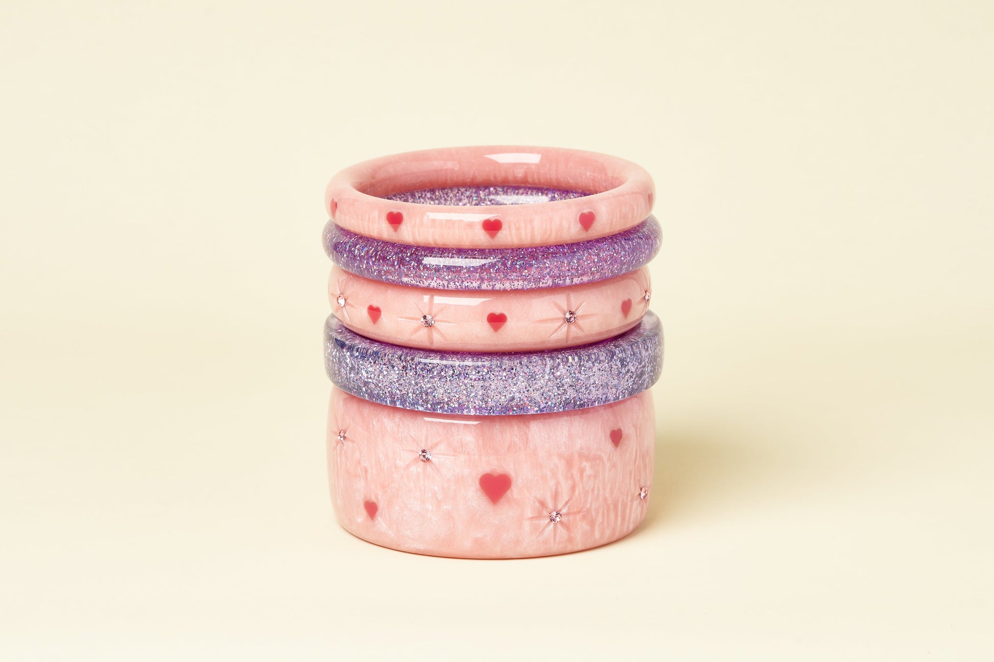 Splendette vintage inspired 1950s Valentine's style pastel pink Sweet Cheeks fakelite bangles stacked with Lilac glitter bangles