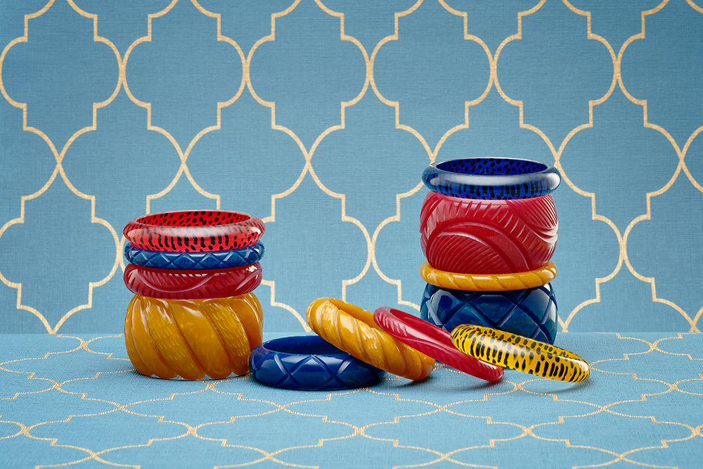Splendette vintage inspired 1940s style display of Autumn 2020 Golden Fakelite bangles in primary colours, Mustard, Bordeaux and Ink, with leopard print bangles