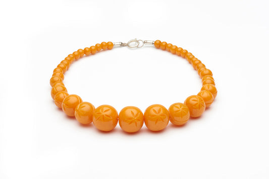 Carved Pale Orange Fakelite Beads