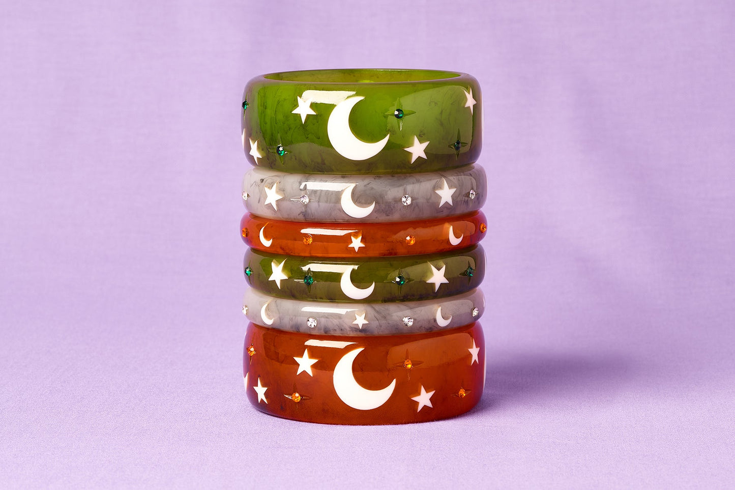 Splendette vintage inspired 1950s Halloween style green Zombie, white Spectre and orange Pumpkin bangles in a stack on purple background