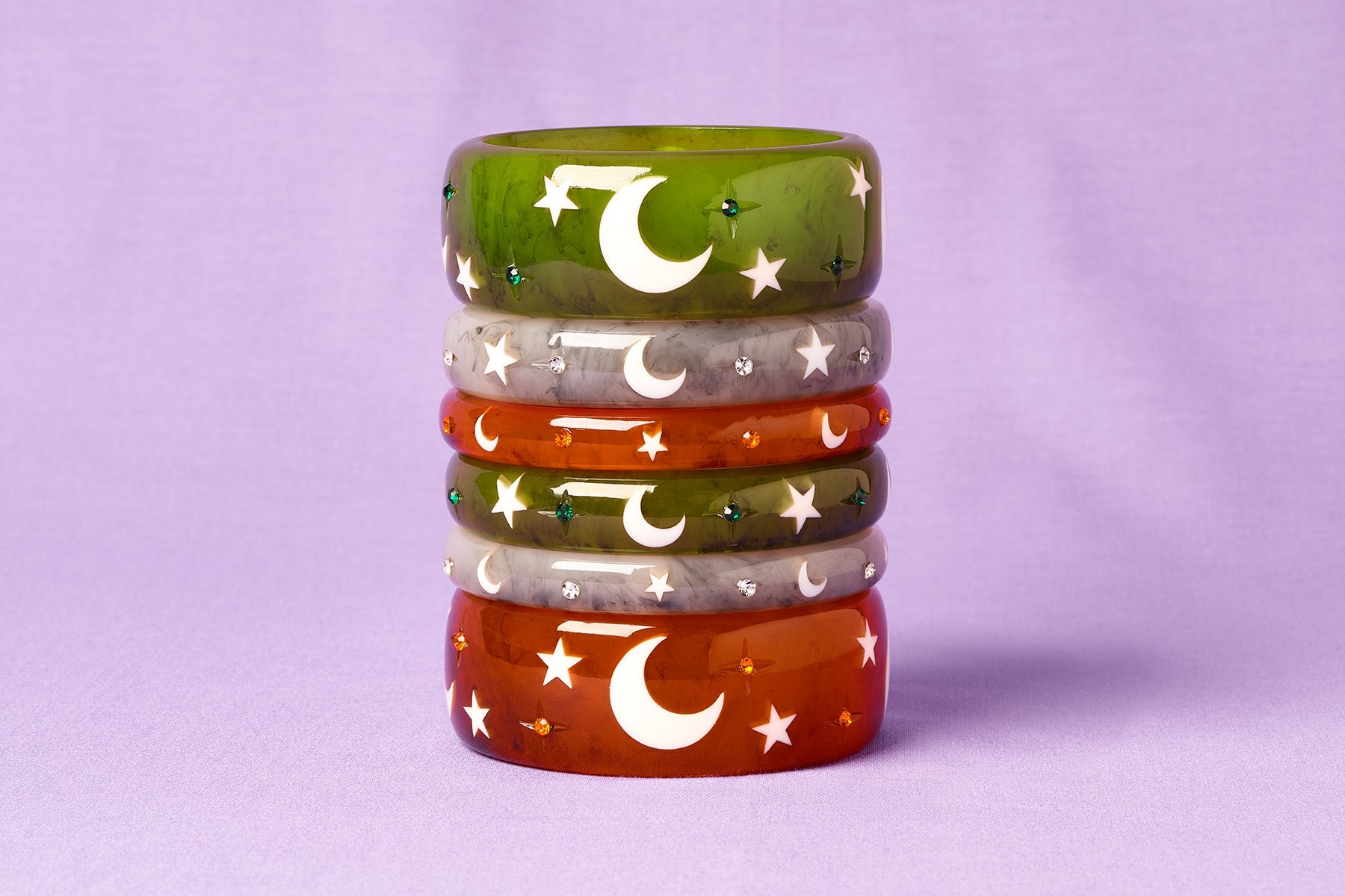 Splendette vintage inspired 1950s Halloween style green Zombie, white Spectre and orange Pumpkin bangles in a stack on purple background