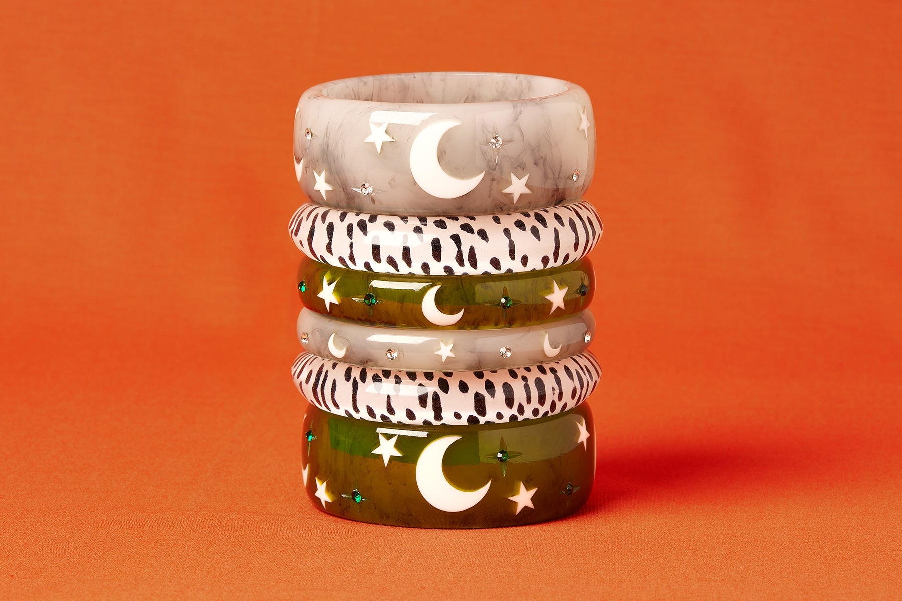 Splendette vintage inspired 1950s Halloween style white Spectre, White Leopard and green Zombie bangles in a stack on an orange background