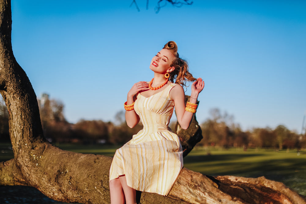 Splendette vintage inspired 1950s pin up style yellow and peachy orange carved Duotone Spring 2021 jewellery worn by Blossom & Buttercups