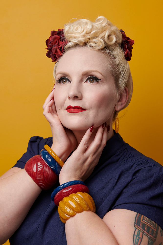 Splendette vintage inspired 1940s Bakelite style Golden Autumn fakelite jewellery model headshot with Bordeaux, Ink and Mustard bangles, Bordeaux necklace and Mustard Drop Hoop Earrings