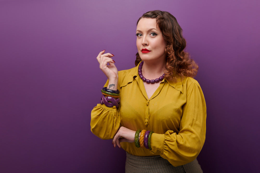 Splendette vintage inspired 1940s Bakelite style Golden Autumn model shot with fakelite jewellery. Plum, Olive and Mustard bangles with Plum necklace