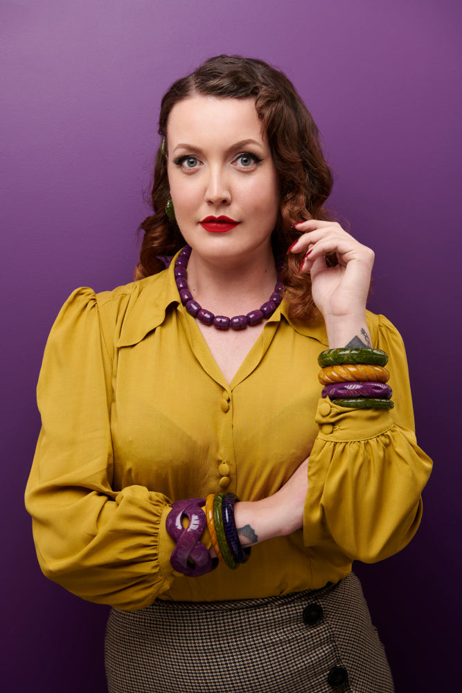Splendette vintage inspired 1940s Bakelite style Golden Autumn model shot with fakelite jewellery. Plum, Olive and Mustard bangles with Plum necklace vertical