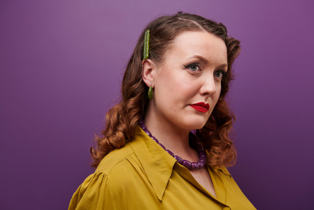 Splendette vintage inspired 1940s Bakelite style Golden Autumn model shot with fakelite jewellery. Plum necklace, Olive hoop earrings and Olive Hair Barette