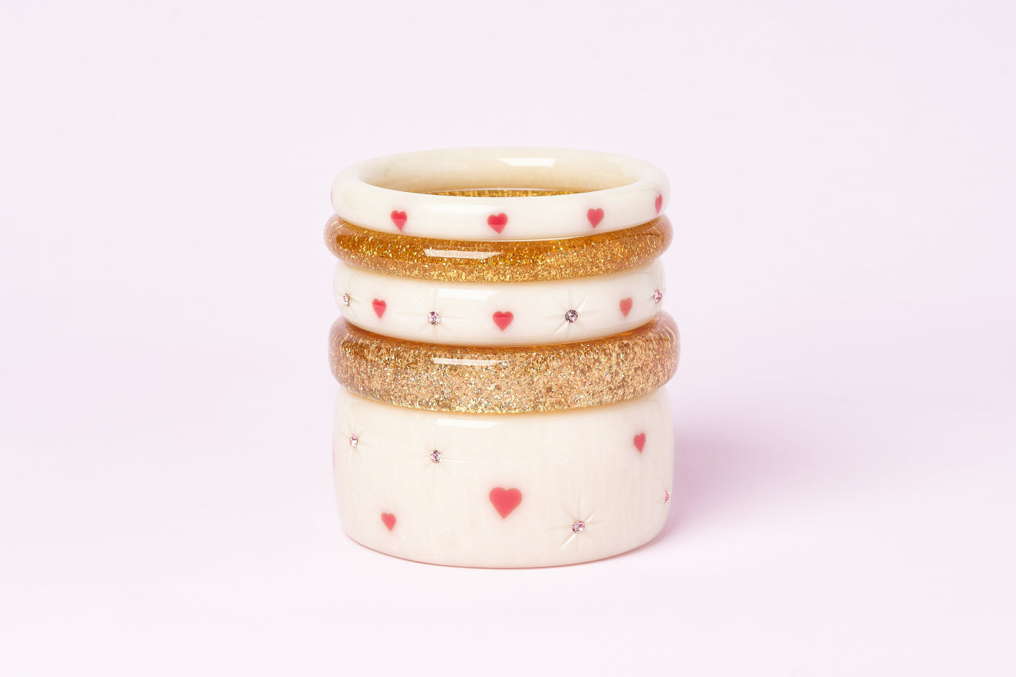 Splendette vintage inspired cute 1950s style carved white fakelite Sugar bangles with Pale Gold Glitter bangles in a stack