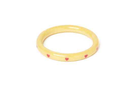Splendette vintage inspired 1950s kitsch Valentine's style pastel yellow carved fakelite Narrow Honey Bunch Starburst Bangle